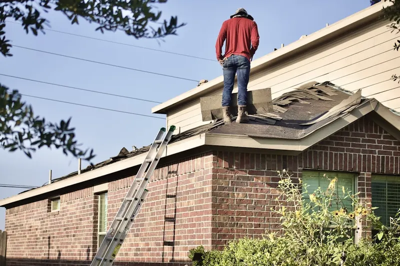 Professional roofer working on a residential roof in Red Bird Addition